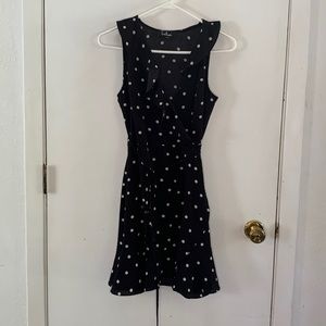 Lulu's Nightlife black sleeveless wrap dress with white polka dots and ruffles